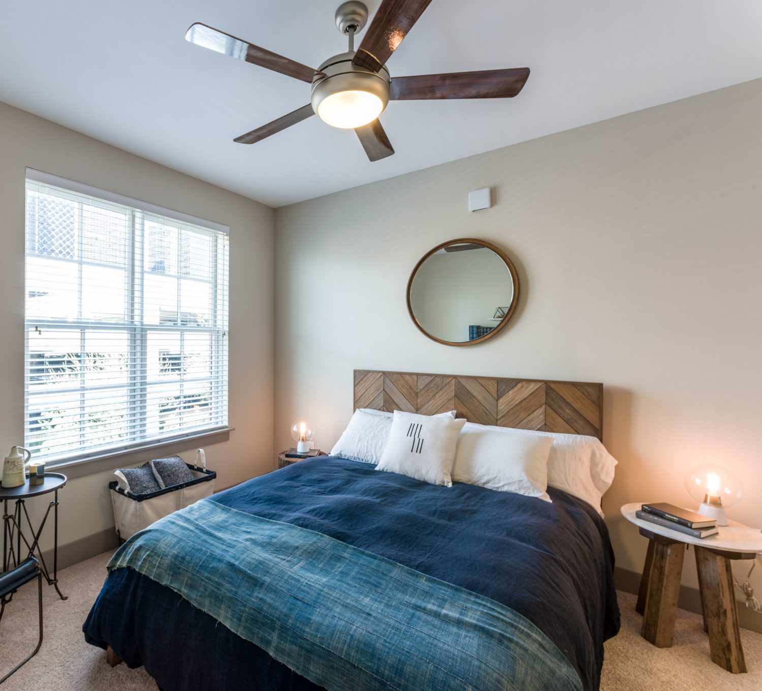 Bedroom with large windows and ceiling fan