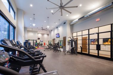 The Paramount - Fitness Center with modern fans and extensive equipment.