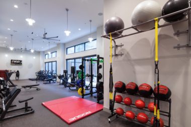 The Paramount - Clean and organized fitness center with large windows and lighting features and state of the art fitness equipment.