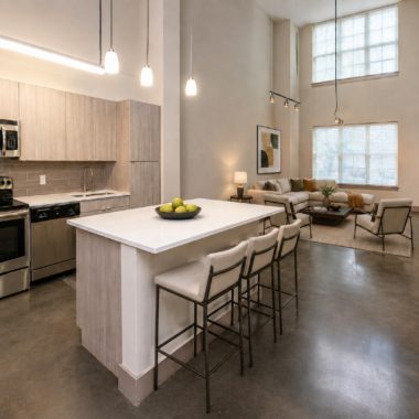 large double height loft living space with open kitchen looking towards living room